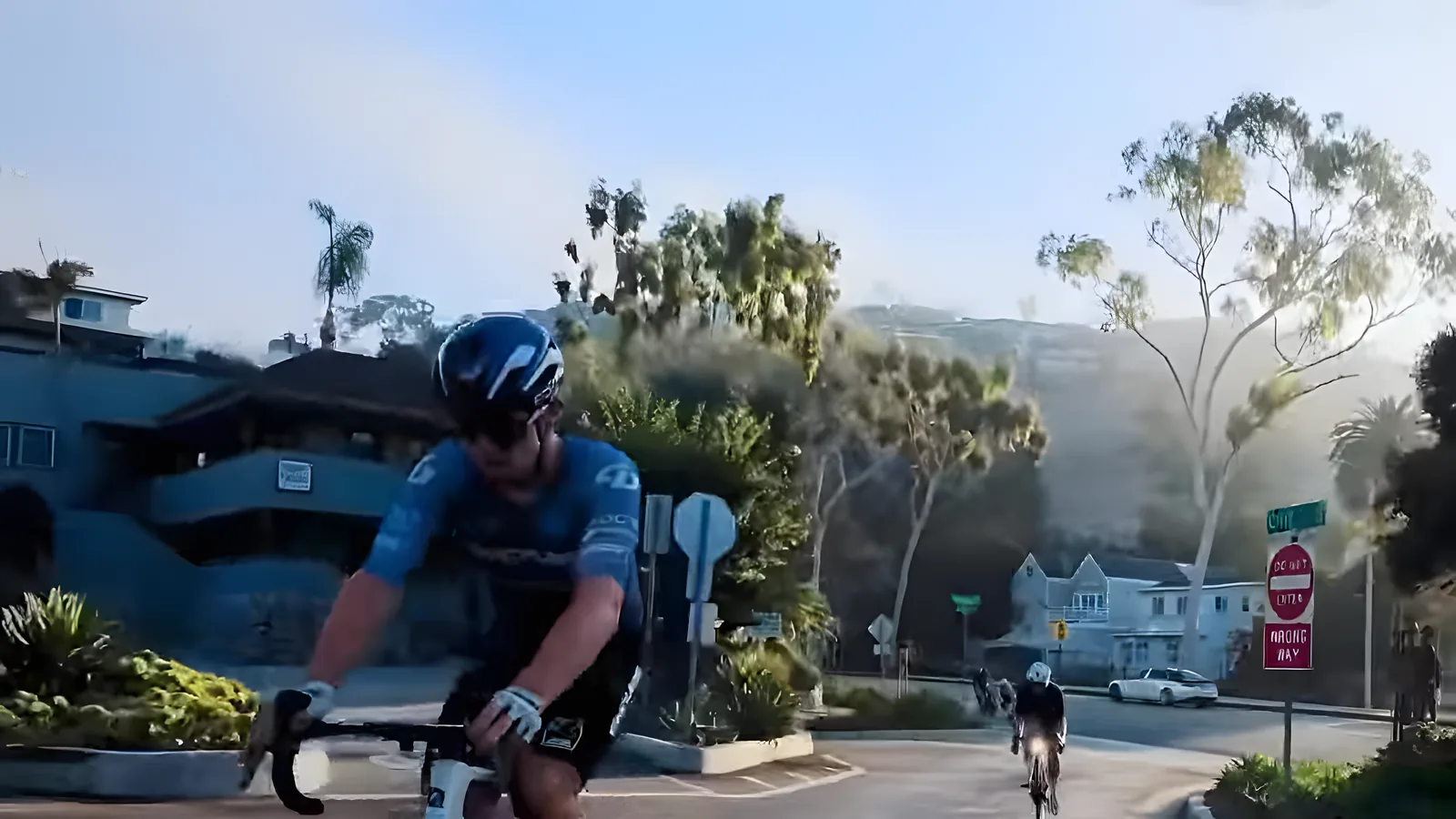 Bus Stop rider passing hillside homes near the coast