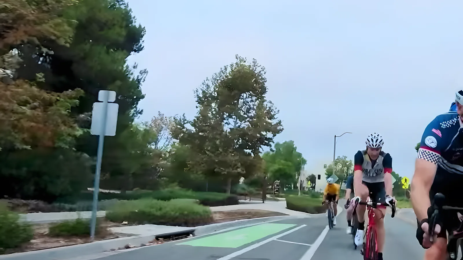 Coffee Crew group rolling past a green bike lane